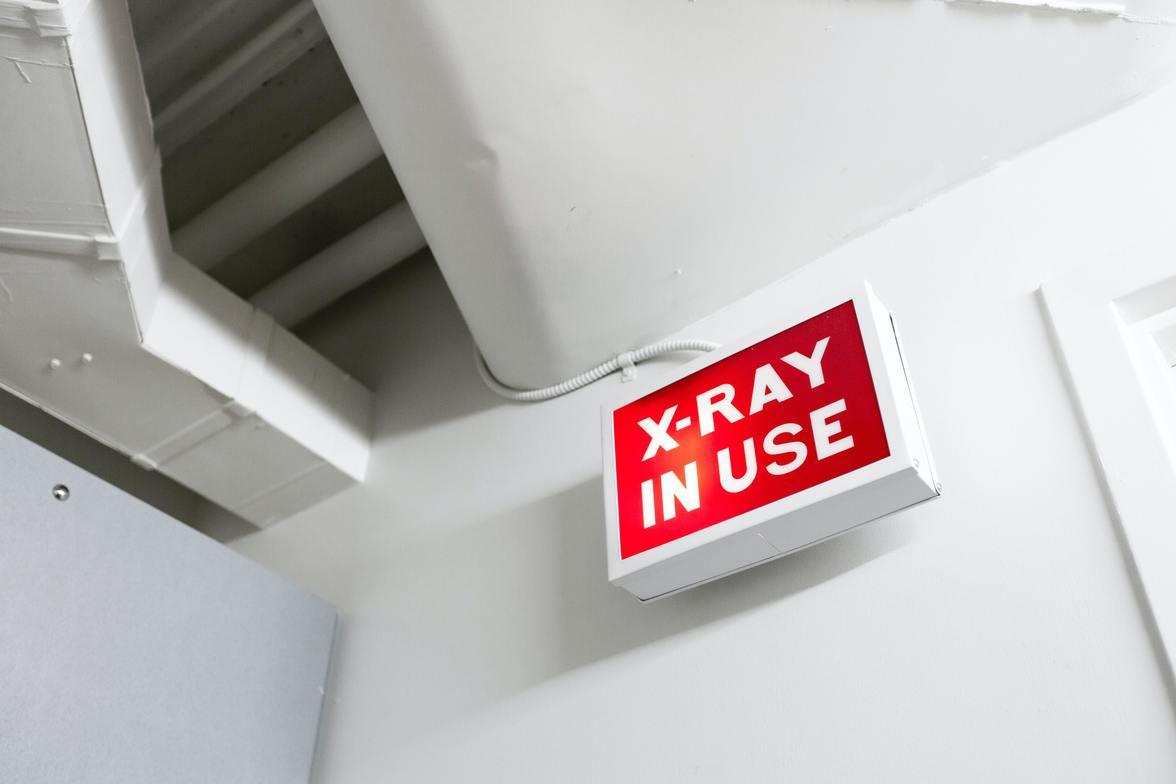 red x-ray sign white walls